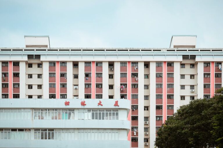 A multi-story apartment building displaying Chinese characters, set against a clear sky.