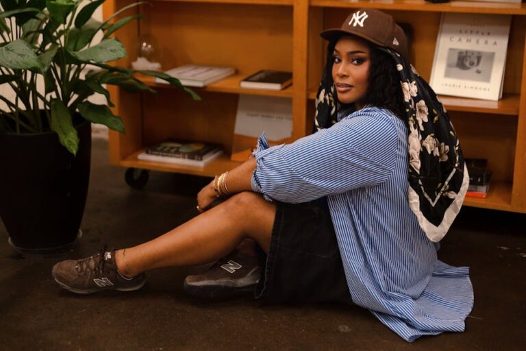 Woman sitting comfortably in a cozy indoor setting, embodying casual fashion and modern style.