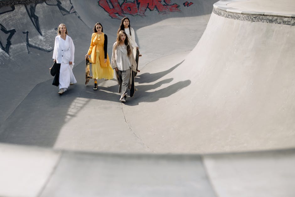 Group of stylish women walking at a skatepark with skateboards, merging fashion and urban culture seamlessly.