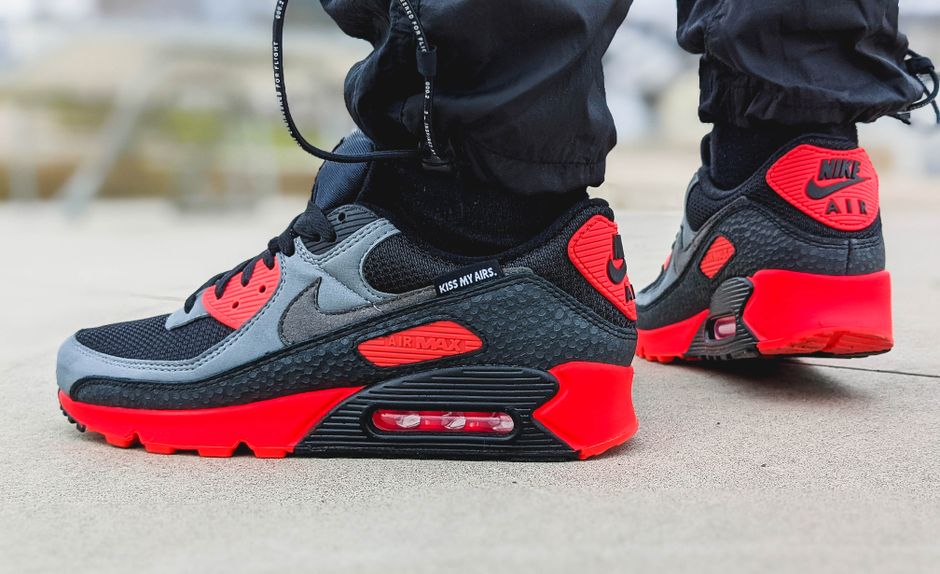 Close-up view of trendy Nike Air Max sneakers in vibrant red and black tones.